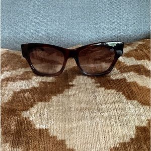 These sunglasses are LeSpecs, the lens is a light brown ombré, size small